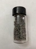 Titanium group: dull gray |ti| pieces, dull gray |zr| chunks, and a few small slugs of |hf| in bottles