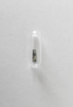 A very, very, very minuscule amount of Technetium metal electroplated onto the surface of a Gold metal strip. Gold is yellow, but the silvery color of Technetium metal is clearly visible. Samples of pure Technetium are not possible to obtain privately, almost certainly because of its radioactivity. Also shown are two screenshots from a radio-analysis program which identifies Technetium.