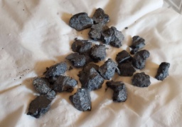 Several dark, oxidized chunks of Samarium