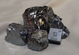 Silicon cube and several chunks. Also, a crystal of quartz (Silicon Dioxide)