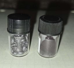 The two commonly encountered forms of Selenium: gray pellets and red powder in separate bottles.