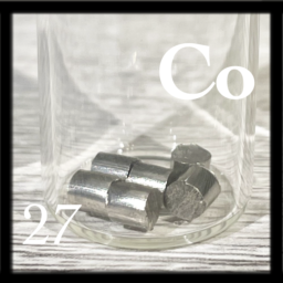 Six silvery, shiny Cobalt pellets in a bottle