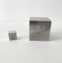 Two Alumin(i)um cubes: a 1 cm cube on the left, and a 1 inch cube on the right