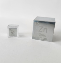 Two cubes of polished zinc metal: 1 cm cube on the left in a clear case, and a 1 inch cube on the right