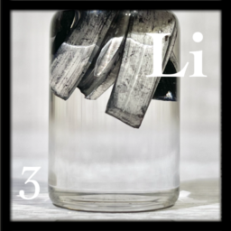 Lithium chunks in what appears to be mineral oil. As Lithium is so light, the chunks float to the top of the bottle.