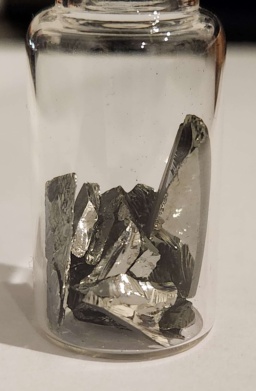 Shiny, glassy chunks of Germanium in a bottle