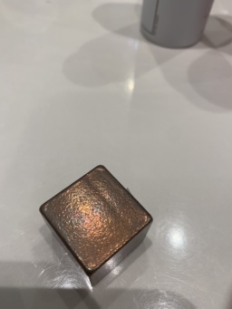 A copper cube measuring 25.4mm (1") on each side, purchased from a metaphysical store. The text around the square reads, clockwise from the top: COPPER / 8.92 g/cc / 5 OUNCES / 1085°C. The square icon itself reads: 29 / Cu / 63.55.