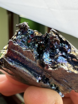 100 gram Vanadium metal chunk, showing blue, green, gold, and purple colors resulting from a thin layer of oxidation.