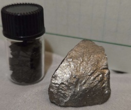 Heavily oxidized chips of Manganese, and a large slightly-brassy-tarnished chunk of Manganese