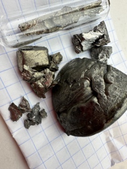 Four chemical elements were named after the town of Ytterby, Sweden, where many rare-earth elements were discovered from the ores mined there. In this photo is |y| (large chunk), |yb| (in ampoule), |tb| (brassy pieces), |er| (silvery pieces). Also included are small pieces of dull, slightly oxidized |ho|, which takes the name of Stockholm, Sweden.