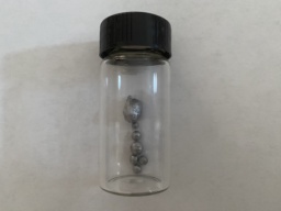 One medium and 6 or 7 small beads of Beryllium in a bottle