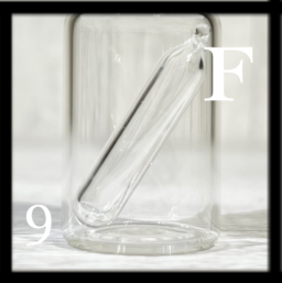 Clear ampoule that probably contains 33% Fluorine, itself in a bottle.