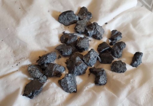 Several dark, oxidized chunks of Samarium