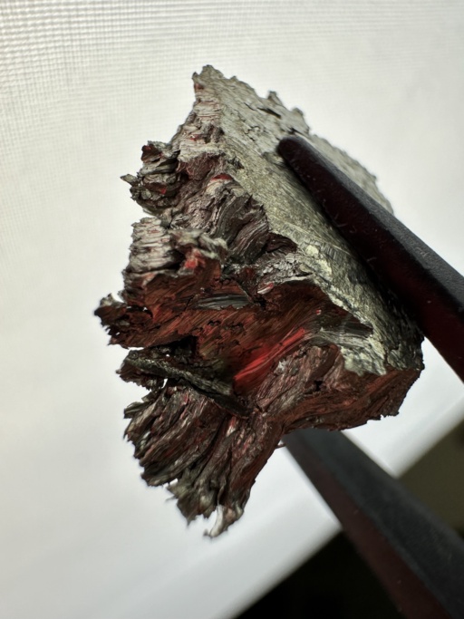 Macro photograph of a Scandium metal chunk. Its dendritic (hair-like) structure is clearly visible.