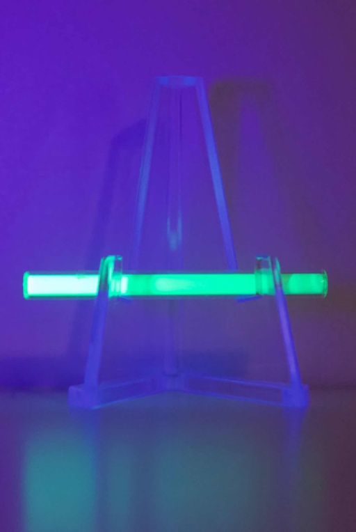 A small amount of radioactive Tritium (Hydrogen with one proton and two neutrons) in a tube that has been coated on the inside with a phosphor. The radioactivity of the Tritium causes the phosphor coating to glow green in the dark.