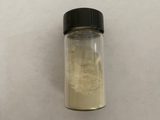 Finely powdered yellow Sulfur in a bottle. Clumps have formed.