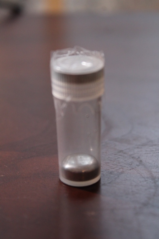 A very small sample of liquid Mercury metal in a clear container