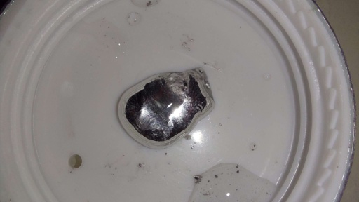 Close-up photo of Gallium in the cap of a bottle