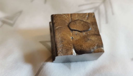 50 or 60 gram block of Gadolinium metal. This sample looks like a brownie slice with a caramelized top side!