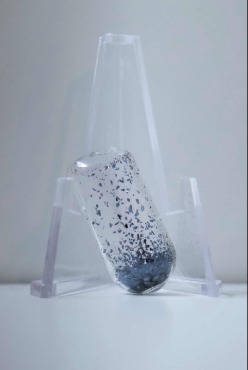 1 gram of dark purple Iodine pellets in an ampoule, resting on a clear folding stand