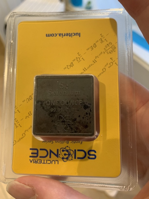 Contributor writes, “Selenium billion from Luciteria, from top to bottom the sample reads: Se34 / Selenium / ONE OUNCE/ 99.9% PURE with the Luciteria Science atom logo below it. The packaging has “Exotic Bullion Series” in italics below the main Luciteria logo, and at the bottom their website, luciteria.com. The packaging also has several mathematical formulas and equations on it, but the contributor does not recognize any of them.”