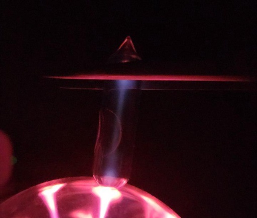 Ampoule of Oxygen next to a plasma globe, glowing a dim lilac color