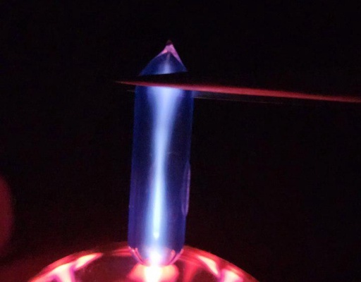 Ampoule of Krypton gas on top of a plasma globe, glowing a bright white (ever so slightly blue) color