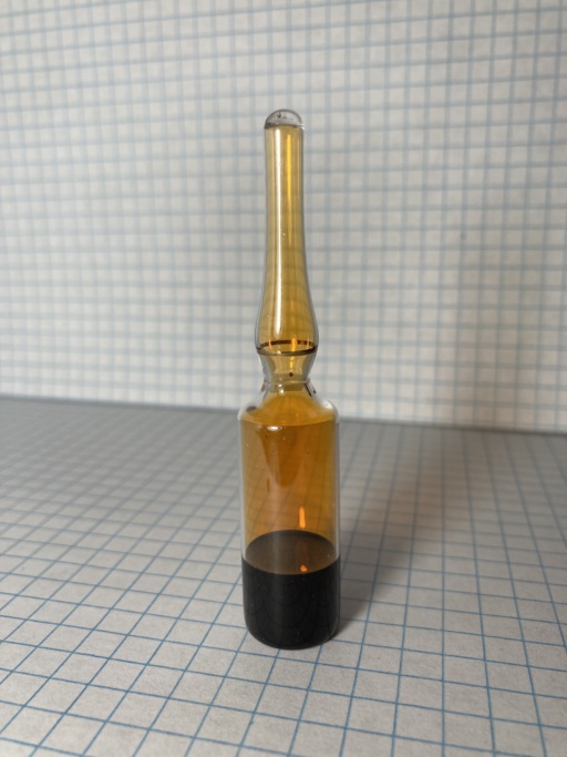 Bromine liquid and gas in an ampoule. Bromine is one of two elements that are liquid at room temperature, and it vaporizes easily. The intensely dark brown liquid, and orange vapor are clearly visible.