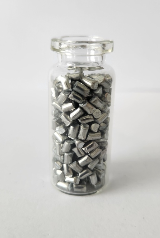 Zinc pellets in a glass bottle