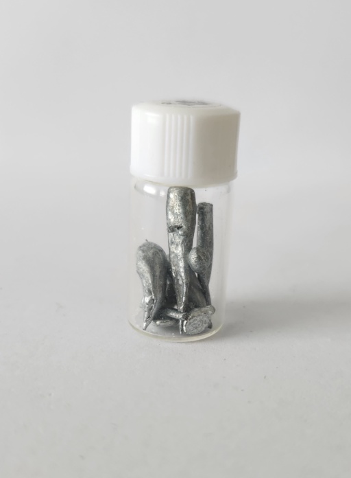 Small finger-shaped Zinc ingots in a bottle