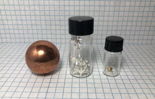 The Copper metal group: a large |cu| sphere, beautiful |ag| metal crystal, and a 1 gram bead of |au|