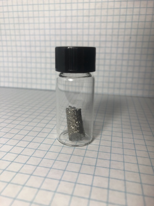 Small single crystal of Hafnium in a small jar