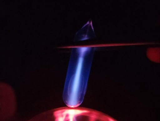 Argon gas in an ampoule on top of a plasma globe, glowing a blue-white color