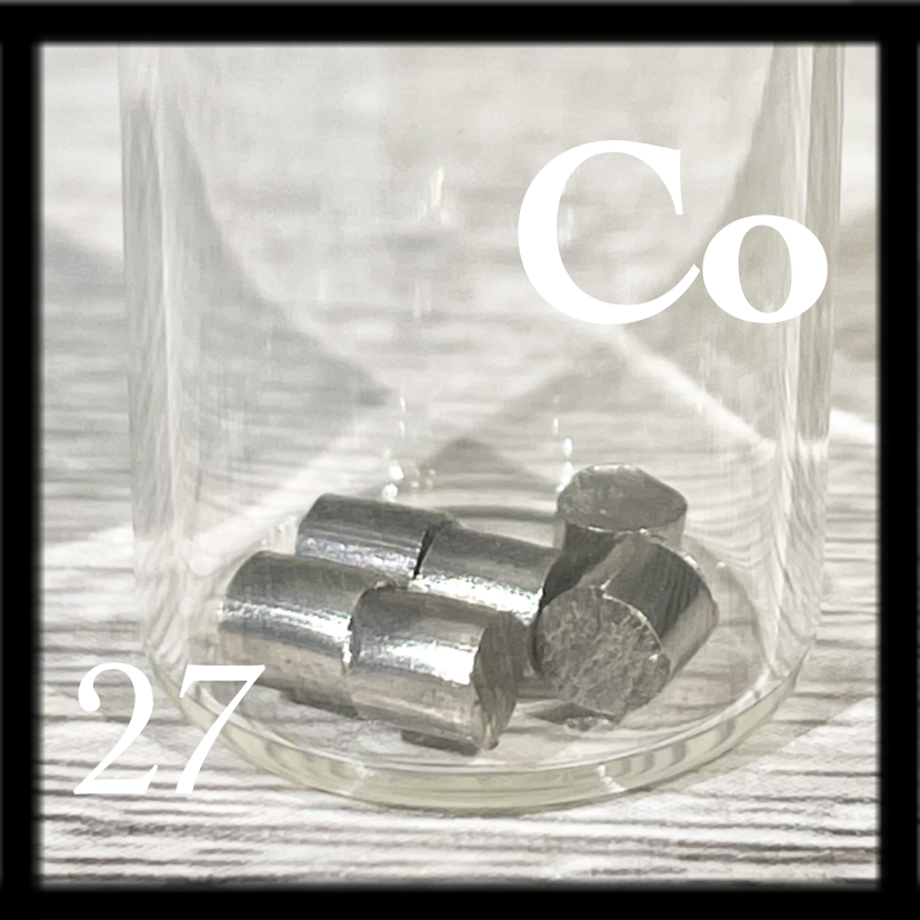 Six silvery, shiny Cobalt pellets in a bottle